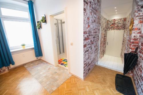a room with a brick wall and a window at City Residences Koblenz in Koblenz