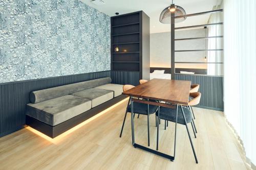 a dining room with a couch and a table at Long Vacation Resort in Fukuoka