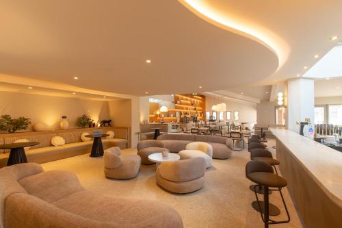 a salon with couches and chairs and a waiting room at Golden Tulip Avignon Le Paradou in Avignon
