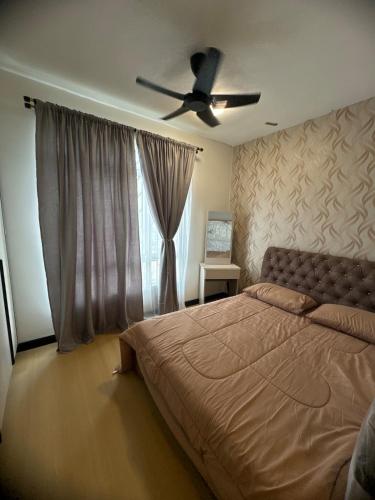 a bedroom with a bed and a ceiling fan at Botaniqa Residence in Puchong