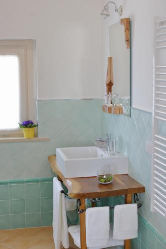 a bathroom with a sink and a table with towels at Alla Bigattiera in Osimo