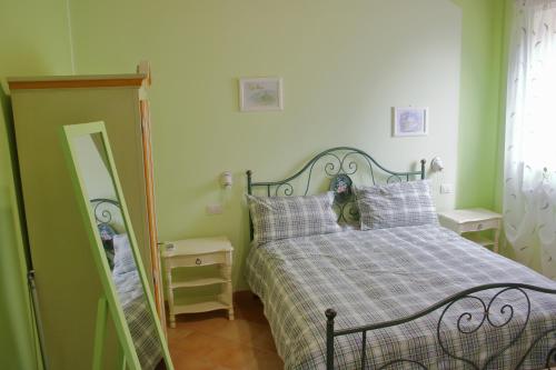 een slaapkamer met een bed en een spiegel bij Alla Bigattiera in Osimo