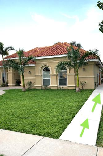 a house with green arrows pointing to a yard at Room, Private Restroom and Entrance in Edinburg