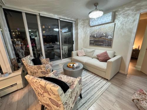 a living room with two chairs and a couch at Beautiful Bright with water view AC DT 2BR 2BTh 3BD sleeps 6 guests in Vancouver