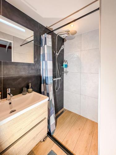 a bathroom with a sink and a shower at Sea You Soon in Callantsoog