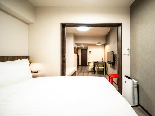a bedroom with a bed and a dining room at Section L Akihabara in Tokyo