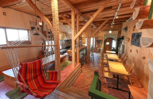 a room with chairs and a hammock in it at SappoLodge in Sapporo