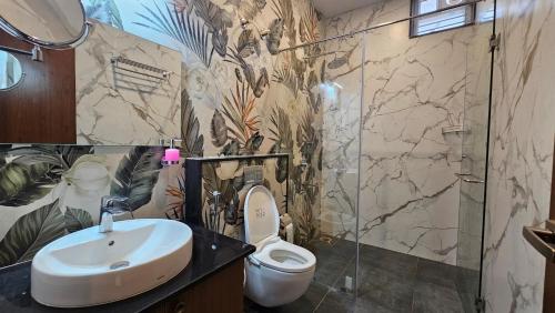a bathroom with a sink and a toilet at Stellar 23 Resort in Whitefield