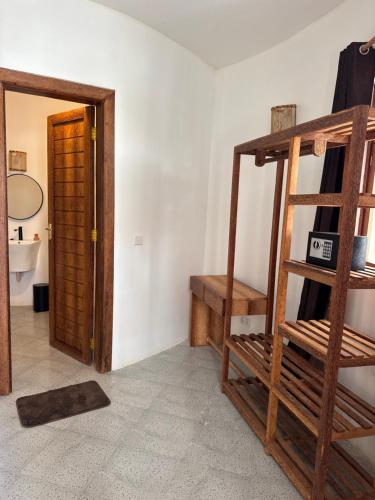 a room with a wooden ladder and a bathroom at Jumbo Resort in Paje