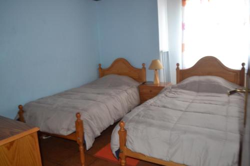 two beds sitting next to each other in a bedroom at TINA 3B - Alojamento Local - RRAL 760 in Porto Martins