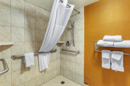 a bathroom with a shower with white towels at Comfort Inn & Suites Phoenix North - Deer Valley in Phoenix