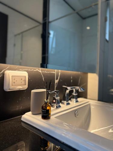 a bathroom counter with a sink and a mirror at Luxury house for rent near Suvarnabhumi Airport in Sathani Lat Krabang