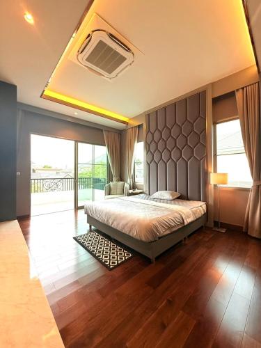 a bedroom with a bed and a large window at Luxury house for rent near Suvarnabhumi Airport in Sathani Lat Krabang