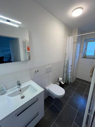 ein Badezimmer mit einem weißen Waschbecken und einer Toilette in der Unterkunft Small Sally in Gladbeck