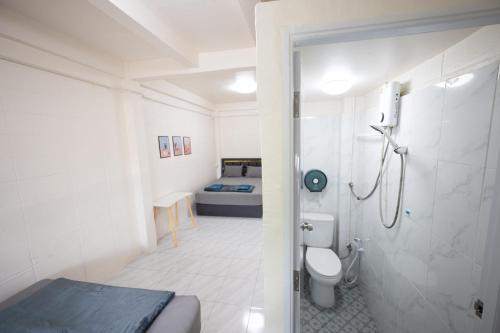 a bathroom with a shower and a toilet and a bed at ดอนเมือง 301 Near DMK Airport BTS Wat PhraSi in Bang Khen