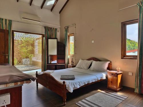 a bedroom with a bed and a window at Mervins & Indus Residence in Colombo