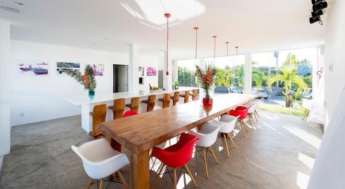 a dining room with a large wooden table and chairs at B Blue Beachouses in Itacimirim