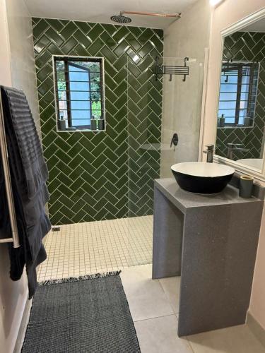 a bathroom with a sink and a mirror at Avo 2 on 27 Drew in Howick
