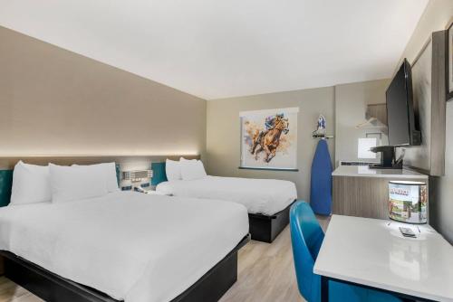 a hotel room with two beds and a desk at Quality Inn Ruidoso in Ruidoso
