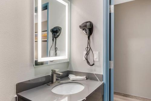 a bathroom with a sink and a hair dryer at Quality Inn Ruidoso in Ruidoso