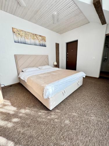 a bedroom with a large white bed in a room at Yu-home in Mukacheve