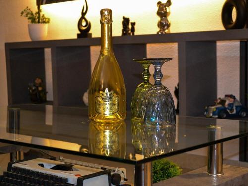 two glass bottles sitting on top of a glass table at Villa Alaya in Manduria