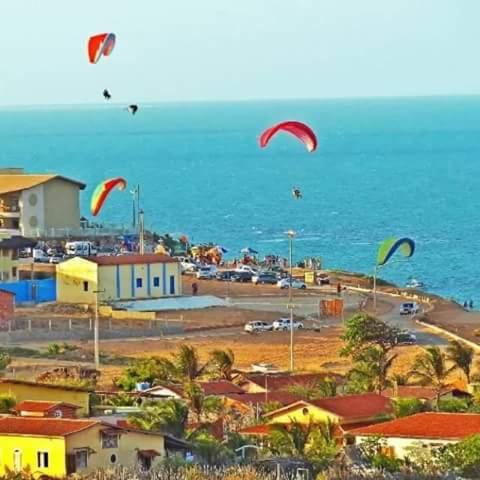a group of kites flying in the sky over the ocean at EmanuelleSales - Corretora de Imóveis - "LUXURY RESIDENCES" creci 16949F in Canoa Quebrada