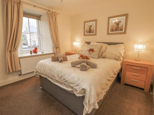 a bedroom with a bed with stuffed animals on it at Old Bridge Inn in Carnforth