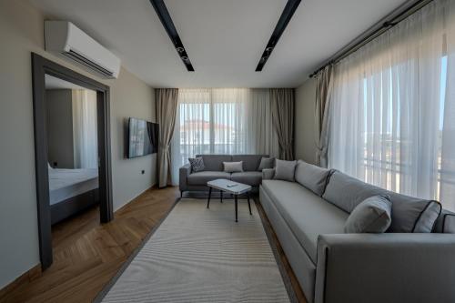 a living room with a couch and a bed at Moon Shine Apart in Altınkum