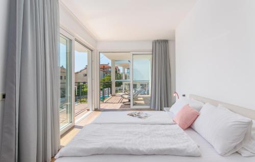 a bedroom with a bed and a large window at VILA PALISKA in Pula