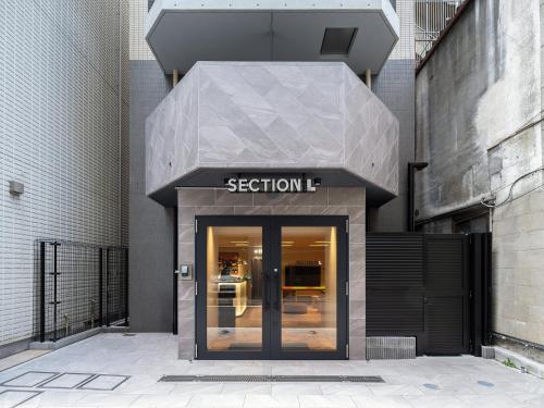 a entrance to a building with a sign on it at Section L Akihabara in Tokyo