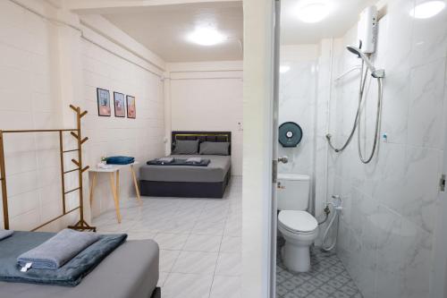 a bathroom with a bed and a shower and a toilet at ดอนเมือง 302 Near DMK Airport BTS Wat PhraSi in Bang Khen