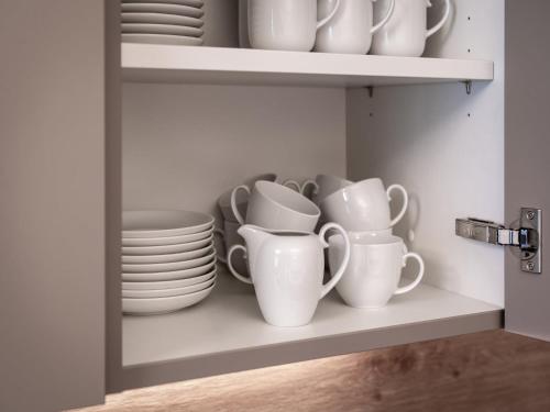 a cupboard filled with plates and cups and dishes at Farmhouse in Schwendau with Ski Storage in Hippach