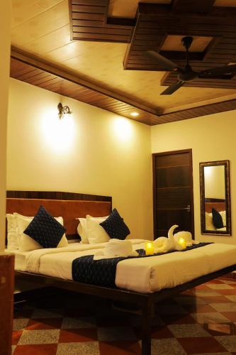 a bedroom with a large bed with swans on it at The Lake Haveli in Udaipur