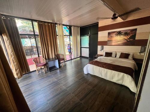 a bedroom with a bed and a large window at Arabian Breeze in Tadri