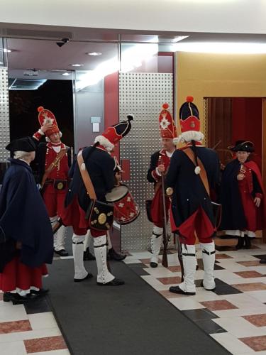 a group of men dressed in costumes in a room at Hotel Central in Timişoara