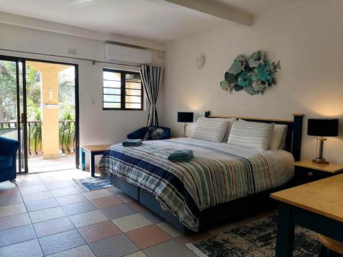 a bedroom with a bed and a sliding glass door at Crayfish Inn No.4 in Ramsgate