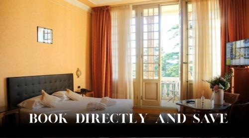 a bedroom with a bed and a large window at Hotel Villa La Bollina in Serravalle Scrivia