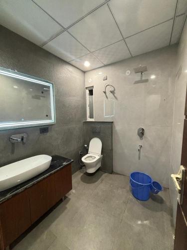 a bathroom with a toilet and a sink at Pg walaah suites in Noida