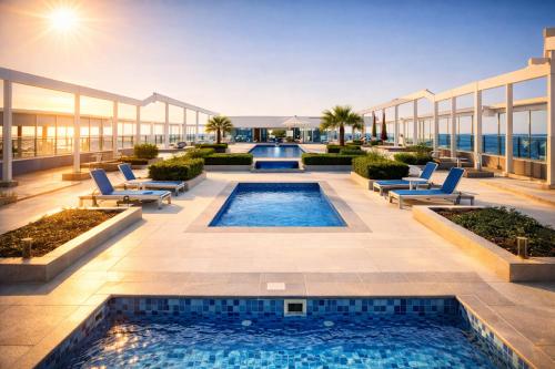 a swimming pool on the roof of a building at Marjan Island Beautiful Apartment Sea Side View Beach Luxury Rooms Ras Al Khaimah UAE in Ras al Khaimah