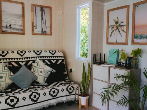 a living room with a couch and a window at Three Palms - Beach Front Tiny House by SP Villa in Nathon Bay