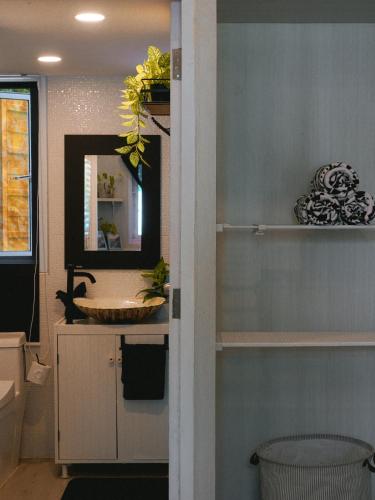 a bathroom with a sink and a mirror at Three Palms - Beach Front Tiny House by SP Villa in Nathon Bay