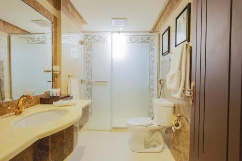 a bathroom with a sink and a toilet and a shower at Rest Night Serviced Apartments- AlHamra in Riyadh