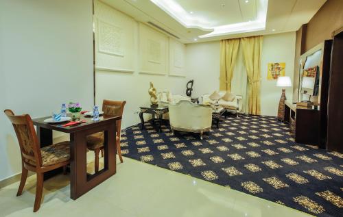 a room with a table and chairs and a living room at Rest Night Serviced Apartments- AlHamra in Riyadh