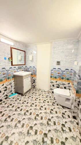 a bathroom with a toilet and a sink at Fun Flock Stay in Mussoorie