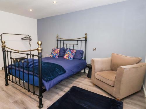 a bedroom with a bed and a chair at Chalet 3 in Ganton