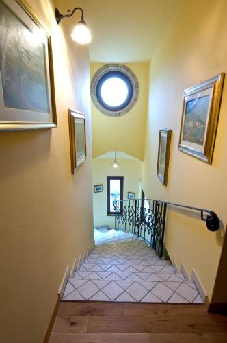 a spiral staircase with a round window on the wall at La Casa Del Palombaro in Ortona