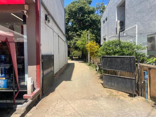 an empty alley next to a building at Cattleya Guest House in Tissamaharama