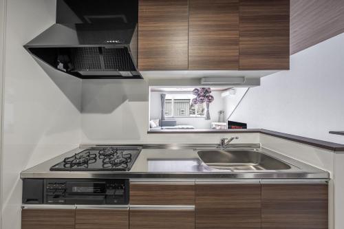 a kitchen with a sink and a stove at Hills Niseko A in Niseko