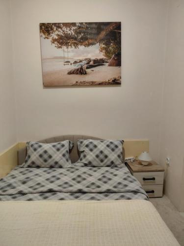 a bedroom with a bed and a picture on the wall at Bonaca in Igalo